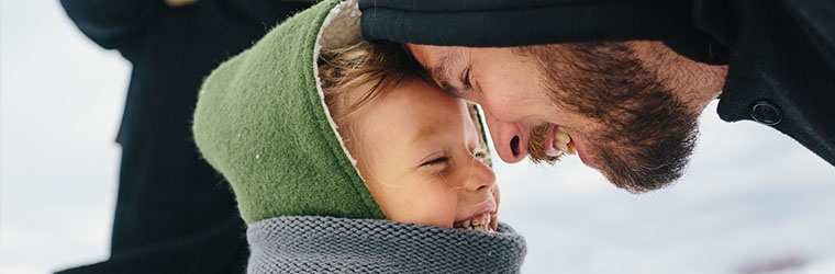 Man touches forehead to his son