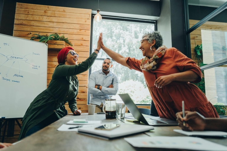 Colleagues giving each other high fives