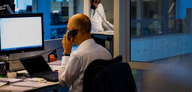 man on phone in the newsroom