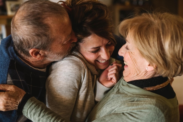 About us - Parents hugging daughter